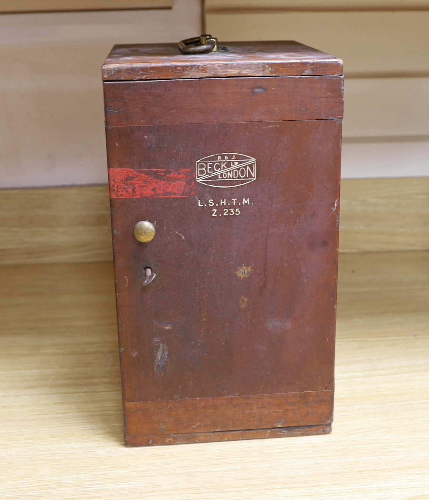An R and J Beck Ltd monocular brass microscope, in wooden case, marked for the London School of Hygiene and Tropical Medicine (Z.235), case 36.5cm high